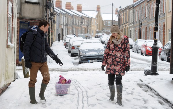 180113 - Heavy Snowfall in South Wales -A couple find an alternative way to tow their baby in the snow in Penarth near Cardiff following heavy snowfall in South Wales