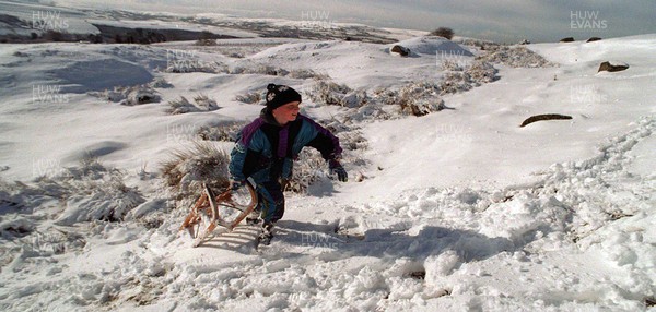 030395 - Weather - Snow in Wales - 11 year old Sion Slyman enjoys the snow on the Black Mountains above Brynamman, West Wales 