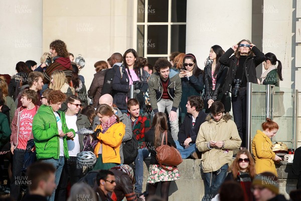 200315 - Picture shows people watching the solar eclipse on the steps of the National Museum, Cardiff