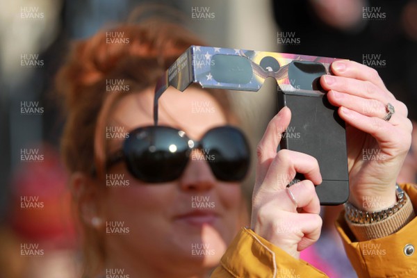 200315 - Picture shows people watching the solar eclipse on the steps of the National Museum, Cardiff