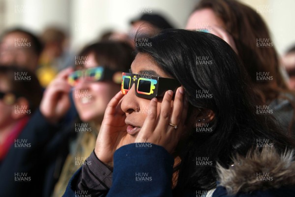 200315 - Picture shows people watching the solar eclipse on the steps of the National Museum, Cardiff