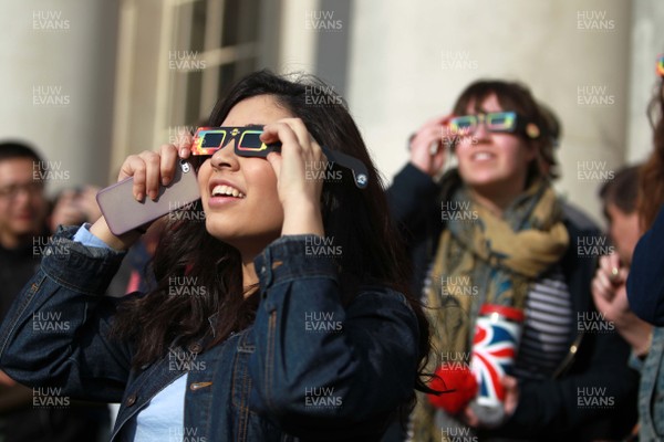 200315 - Picture shows people watching the solar eclipse on the steps of the National Museum, Cardiff