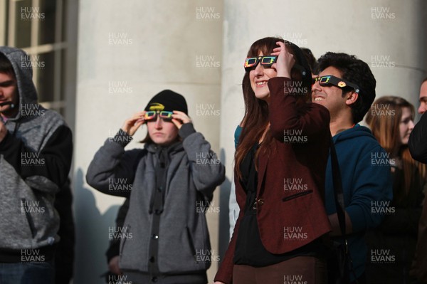 200315 - Picture shows people watching the solar eclipse on the steps of the National Museum, Cardiff