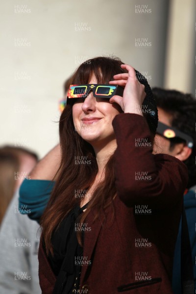 200315 - Picture shows people watching the solar eclipse on the steps of the National Museum, Cardiff