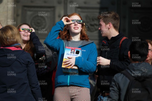 200315 - Picture shows people watching the solar eclipse on the steps of the National Museum, Cardiff