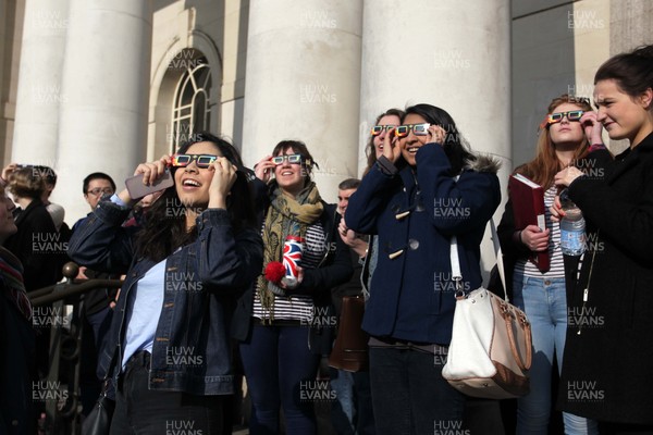 200315 - Picture shows people watching the solar eclipse on the steps of the National Museum, Cardiff