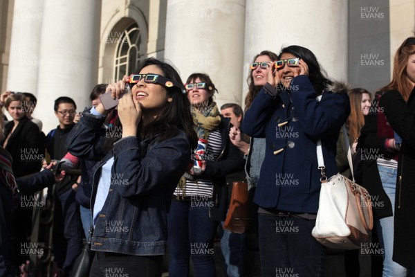 200315 - Picture shows people watching the solar eclipse on the steps of the National Museum, Cardiff