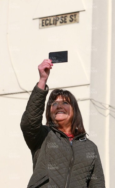 200315 - Picture shows Shirley Debono, a resident of Eclipse Street, Adamstown, Cardiff watching the solar eclipse