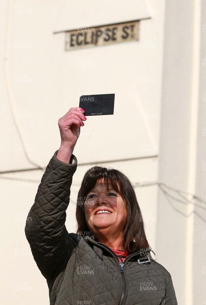 200315 - Picture shows Shirley Debono, a resident of Eclipse Street, Adamstown, Cardiff watching the solar eclipse