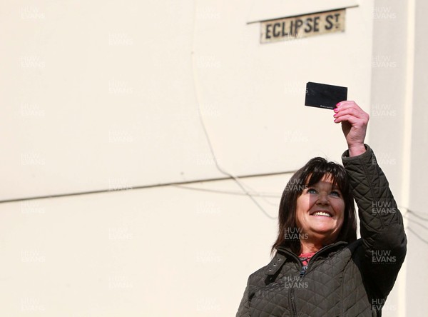 200315 - Picture shows Shirley Debono, a resident of Eclipse Street, Adamstown, Cardiff watching the solar eclipse