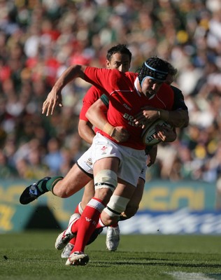 07.06.08 South Africa v Wales, Bloemfontein... Wales Jonathan Thomas is tackled by South Africa's Jean de Villiers.   