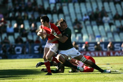 07.06.08 South Africa v Wales, Bloemfontein... Wales Stephen Jones is tackled by South Africa's Andries Bekker.   