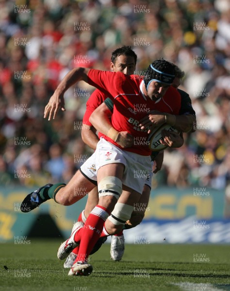 07.06.08 South Africa v Wales, Bloemfontein... Wales Jonathan Thomas is tackled by South Africa's Jean de Villiers.   