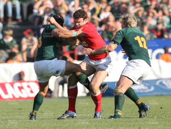 14.06.08 South Africa v Wales (Second Test)... Wales' Jamie Roberts is tackled by South Africa's Adrian Jacobs and Jean de Villiers. 