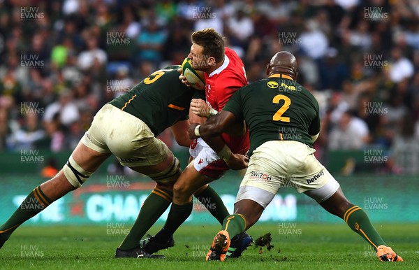 160722 - South Africa v Wales - Castle Lager Incoming Series 2022 Third Test - Dan Biggar of Wales is tackled by Lood de Jager and Bongi Mbonambi of South Africa