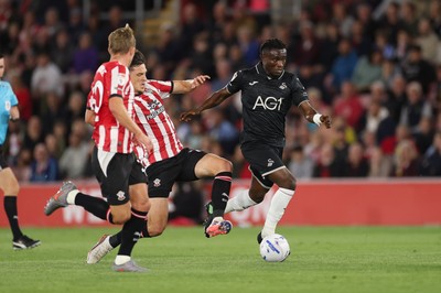 080926 - Southampton v Swansea City, EFL Sky Bet Championship - Joseph Opoku of Swansea City is tackled by Keven Schlotterbeck of Southampton