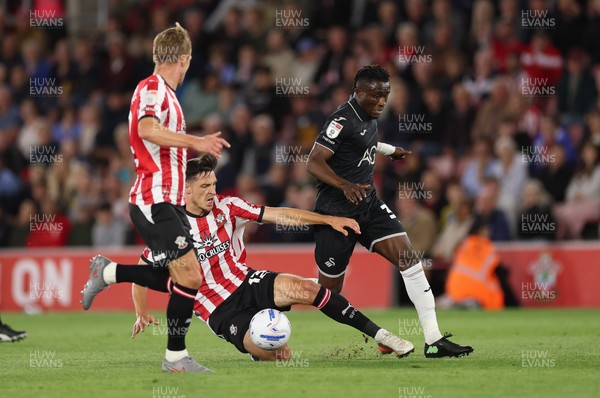 080926 - Southampton v Swansea City, EFL Sky Bet Championship - Joseph Opoku of Swansea City is tackled by Keven Schlotterbeck of Southampton
