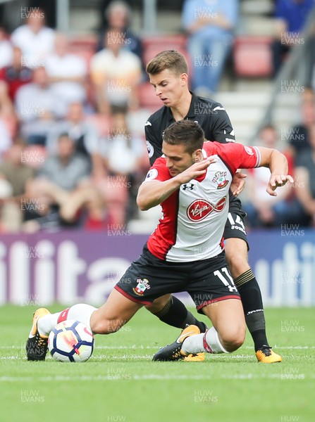 120817 - Southampton v Swansea City, Premier League - Tom Carroll of Swansea City and Dusan Tadic of Southampton compete for the ball