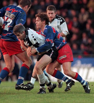 121298 - Stade Francais v Pontypridd - Heineken Cup Quarter Final - Geraint Lewis of Pontypridd is tackled by Cliff Mytton 