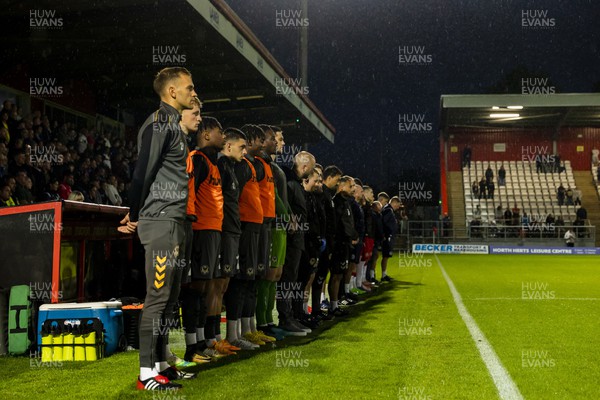 130922 - Stevenage v Newport County - Sky Bet League 2 - Newport County players and staff stand silent in remembrance of the passing of the Queen 