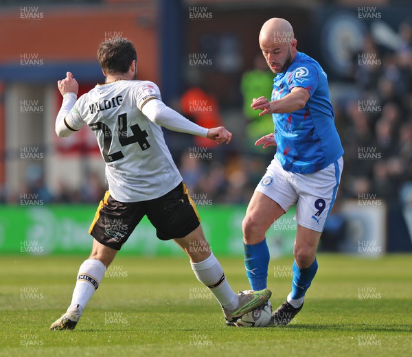 090324 - Stockport County v Newport County - Sky Bet League 2 - Aaron Wildig of Newport County and Paddy Madden of Stockport County