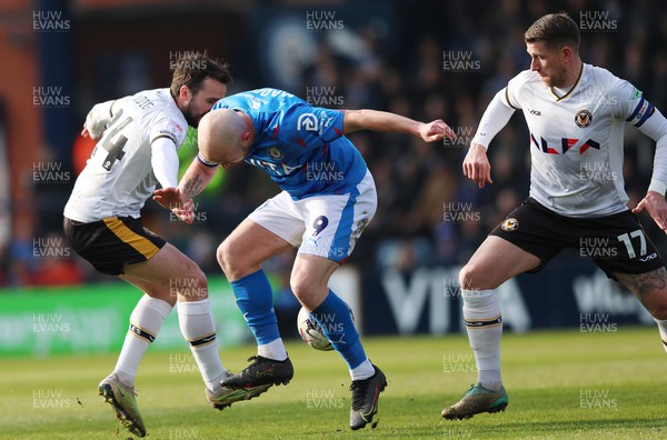 090324 - Stockport County v Newport County - Sky Bet League 2 - Aaron Wildig of Newport County and Scot Bennett of Newport County take the ball off Paddy Madden of Stockport County