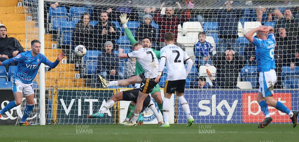 090324 - Stockport County v Newport County - Sky Bet League 2 - Will Evans of Newport County defuses the shot on goal by Paddy Madden of Stockport County