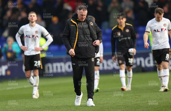 090324 - Stockport County v Newport County - Sky Bet League 2 - Manager Graham Coughlan of Newport County and Lewis Payne of Newport County and Matt Baker of Newport County dejected at the end of the match