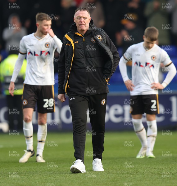 090324 - Stockport County v Newport County - Sky Bet League 2 - Manager Graham Coughlan of Newport County and Lewis Payne of Newport County and Matt Baker of Newport County dejected at the end of the match