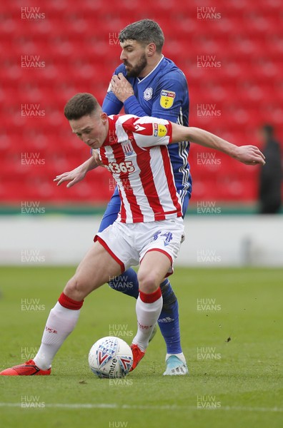 220220 - Stoke City v Cardiff City - Sky Bet Championship - Jordan Thompson of Stoke City is challenged by Callum Paterson of Cardiff   