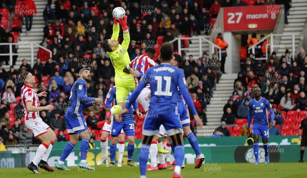 220220 - Stoke City v Cardiff City - Sky Bet Championship - Goalkeeper Jack Butland of Stoke City saves from a cross by Albert Adomah of Cardiff   