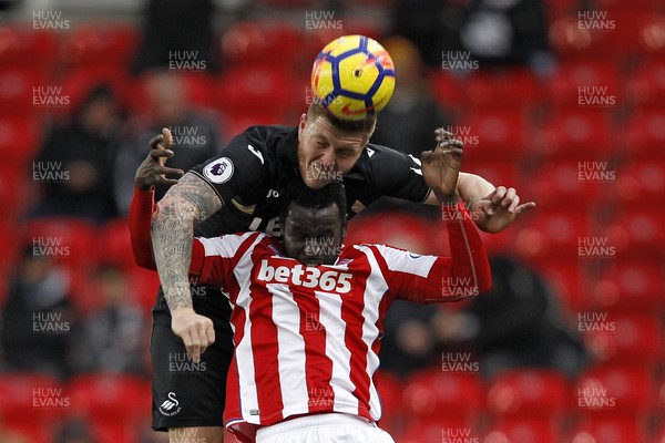 021217 - Stoke City v Swansea City, Premier League - Alfie Mawson of Swansea City (left) in action with Mame Biram Diouf of Stoke City
