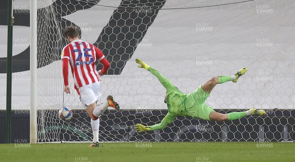 030321 - Stoke City v Swansea City - Sky Bet Championship - Goalkeeper Freddie Woodman  of Swansea can't keep out Nick Powell of Stoke City who scores the 1st goal of the match despite the efforts of Ben Cabango of Swansea