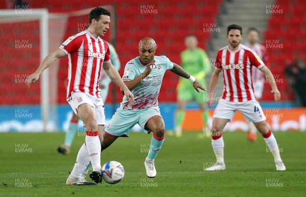 030321 - Stoke City v Swansea City - Sky Bet Championship - Andre Ayew of Swansea tries to take the ball from James Chester of Stoke City