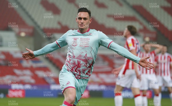 030321 - Stoke City v Swansea City - Sky Bet Championship - Connor Roberts of Swansea celebrates scoring their 1st goal with dejected Stoke behind