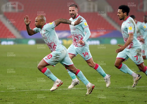 030321 - Stoke City v Swansea City - Sky Bet Championship - Andre Ayew of Swansea celebrates scoring a penalty with Korey Smith and Conor Hourihane