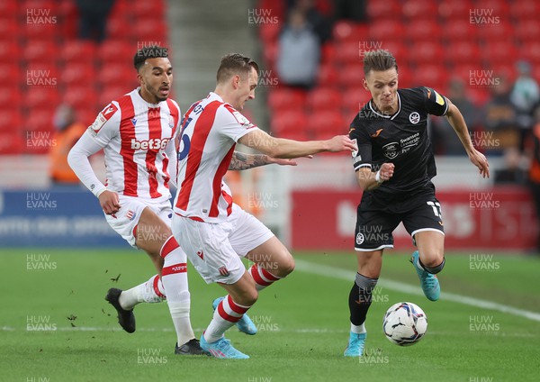 080222 - Stoke City v Swansea City - Sky Bet Championship - Flynn Downes  of Swansea and Jacob Brown of Stoke City