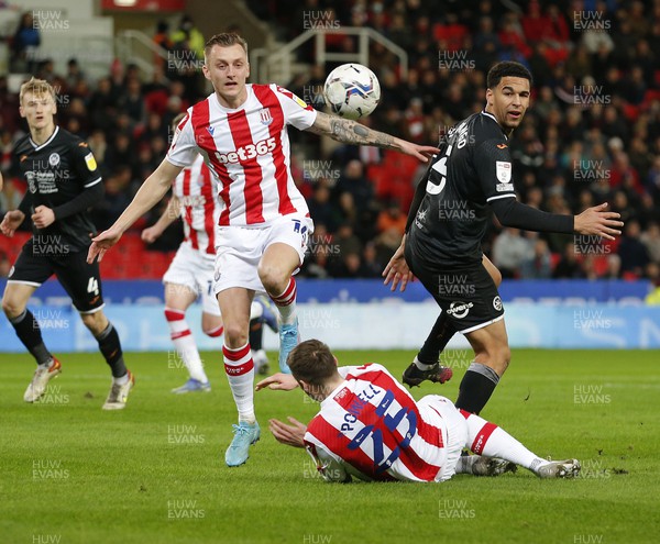 080222 - Stoke City v Swansea City - Sky Bet Championship - Ben Cabango of Swansea cannot get past the defence of Ben Wilmot of Stoke City and Nick Powell of Stoke City
