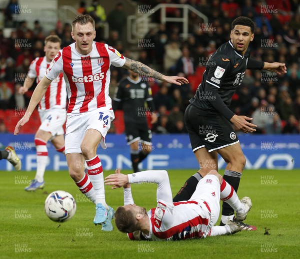 080222 - Stoke City v Swansea City - Sky Bet Championship - Ben Cabango of Swansea cannot get past the defence of Ben Wilmot of Stoke City and Nick Powell of Stoke City