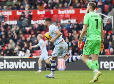 131225 - Stoke City v Swansea City - Sky Bet Championship - Zan Vipotnik of Swansea scores the first goal for Swansea past out of position Goalkeeper Viktor Johansson of Stoke and runs back to kick off