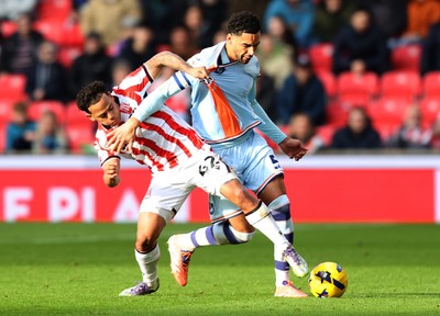 131225 - Stoke City v Swansea City - Sky Bet Championship - Ben Cabango of Swansea is tackled by Million Manhoef of Stoke