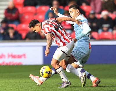 131225 - Stoke City v Swansea City - Sky Bet Championship - Ben Cabango of Swansea is tackled by Million Manhoef of Stoke