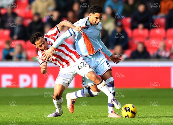 131225 - Stoke City v Swansea City - Sky Bet Championship - Ben Cabango of Swansea is tackled by Million Manhoef of Stoke