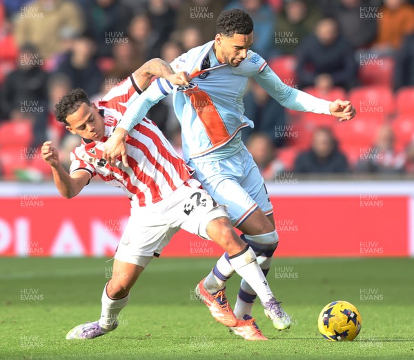 131225 - Stoke City v Swansea City - Sky Bet Championship - Ben Cabango of Swansea is tackled by Million Manhoef of Stoke
