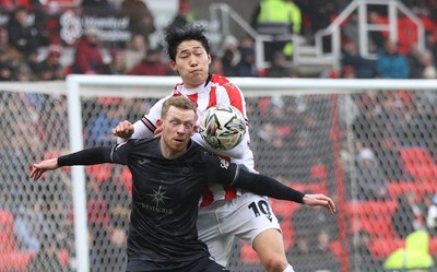 150225 - Stoke City v Swansea City - Sky Bet Championship - Lewis O'Brien of Swansea and Ba Jun-ho of Stoke City