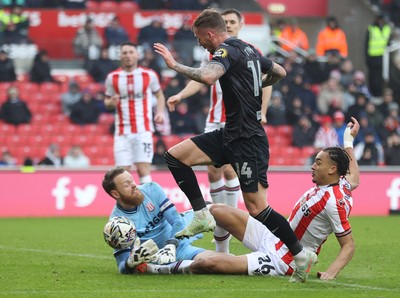 150225 - Stoke City v Swansea City - Sky Bet Championship - Goalkeeper Viktor Johansson of Stoke City fumbles the ball to put it in the path of Josh Tymon of Swansea who scores the 1st goal of the match