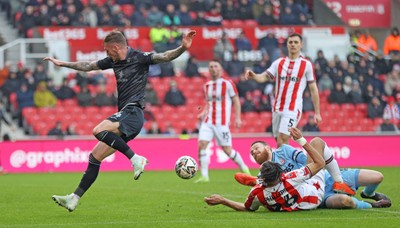 150225 - Stoke City v Swansea City - Sky Bet Championship - Goalkeeper Viktor Johansson of Stoke City fumbles the ball to put it in the path of Josh Tymon of Swansea who scores the 1st goal of the match