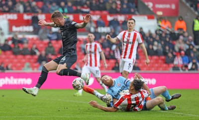 150225 - Stoke City v Swansea City - Sky Bet Championship - Goalkeeper Viktor Johansson of Stoke City fumbles the ball to put it in the path of Josh Tymon of Swansea who scores the 1st goal of the match