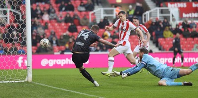 150225 - Stoke City v Swansea City - Sky Bet Championship - Goalkeeper Viktor Johansson of Stoke City fumbles the ball to put it in the path of Josh Tymon of Swansea who scores the 1st goal of the match