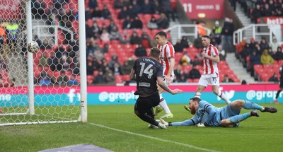 150225 - Stoke City v Swansea City - Sky Bet Championship - Goalkeeper Viktor Johansson of Stoke City fumbles the ball to put it in the path of Josh Tymon of Swansea who scores the 1st goal of the match